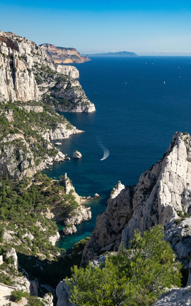 Photograph in aerial view of the Mediterranean sea and some limestone rock formations in Southern France.